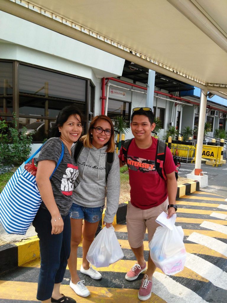 All smiles with their 'pasalubongs' (trip goodies), the trio prepare to board their plane for the short flight back to Manila.